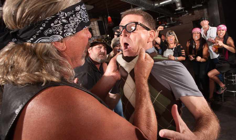 a man in a bandana is holding another man's neck